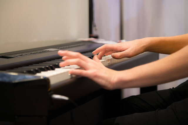 A person's hand playing keyboard