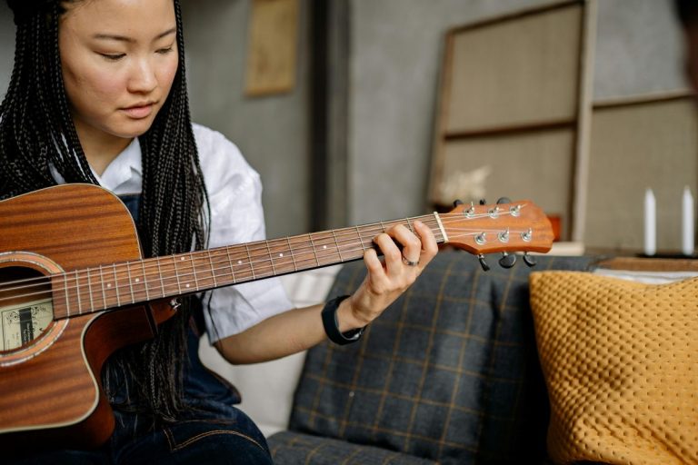 A woman playing an acoustic guitar.