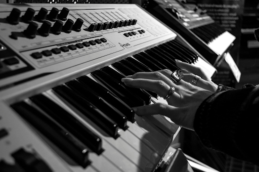 A person playing a synthesizer keyboard