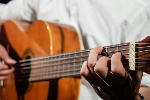 A person playing classical guitar