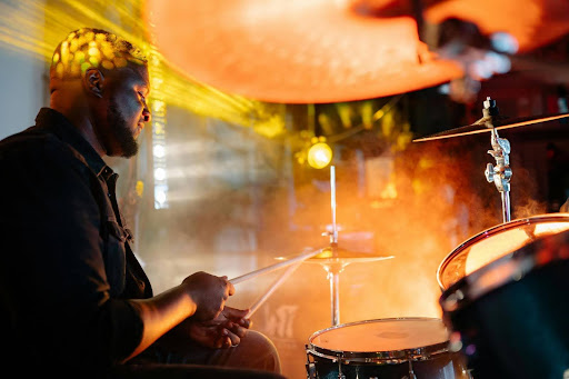 Male drummer playing drums on stage