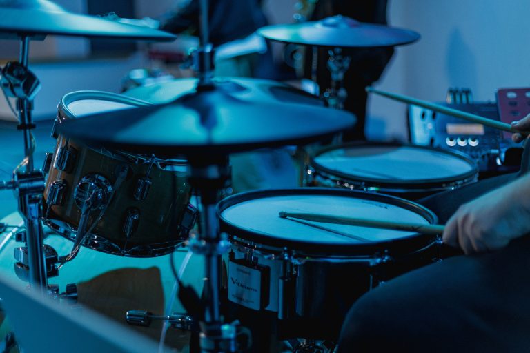 A musician playing an electronic drum kit